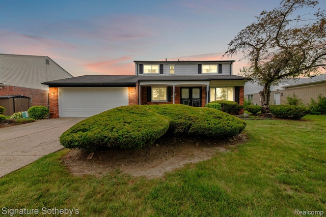 23719 Wendy Ln, Southfield, MI 48075 - traditional home featuring an attached garage, driveway, brick siding, and a yard