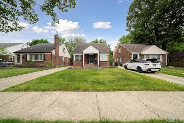 1333 N Franklin St, Dearborn, MI 48128 - bungalow-style house with brick siding, a front lawn, driveway, and a chimney