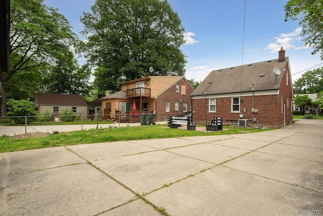 1333 N Franklin St, Dearborn, MI 48128 - back of property with a balcony, a chimney, and brick siding