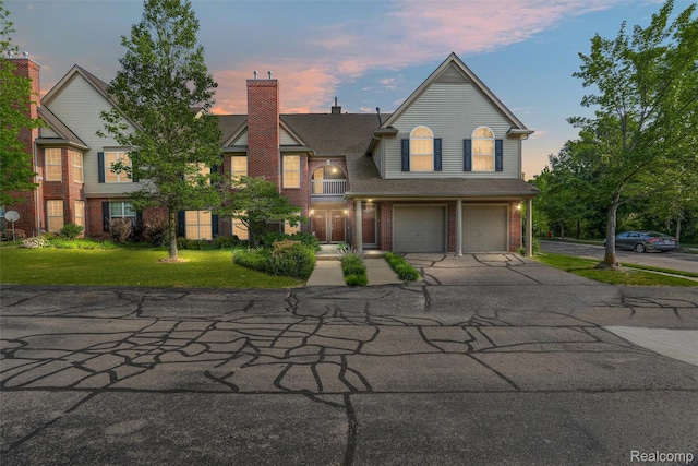28185 Carlton Way Dr, Novi, MI 48377 - view of front of home with driveway, an attached garage, brick siding, and a front yard