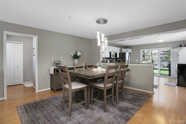 28185 Carlton Way Dr, Novi, MI 48377 - dining area featuring light wood finished floors and a chandelier