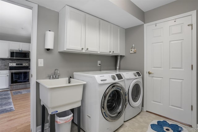 28185 Carlton Way Dr, Novi, MI 48377 - laundry area with washing machine and clothes dryer and cabinet space
