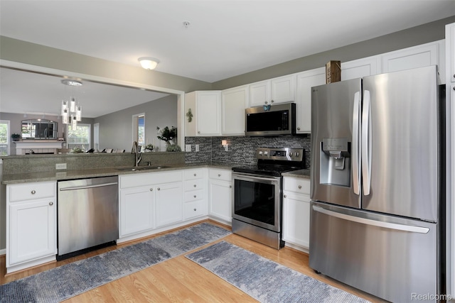 28185 Carlton Way Dr, Novi, MI 48377 - kitchen featuring appliances with stainless steel finishes, white cabinets, and light wood-type flooring