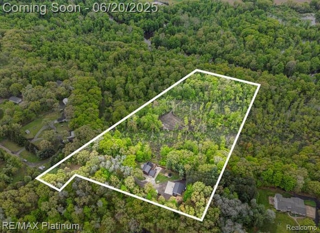 3199 N Loop Ct, Middleville, MI 49333 - aerial view of property and surrounding area with a forest and property boundaries highlighted