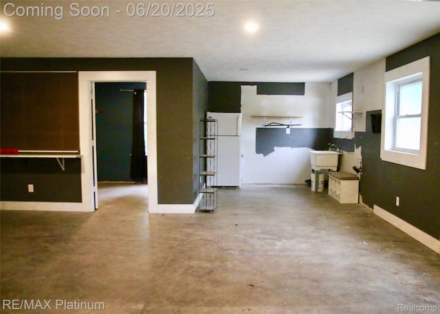 3199 N Loop Ct, Middleville, MI 49333 - unfurnished living room featuring finished concrete floors and baseboards
