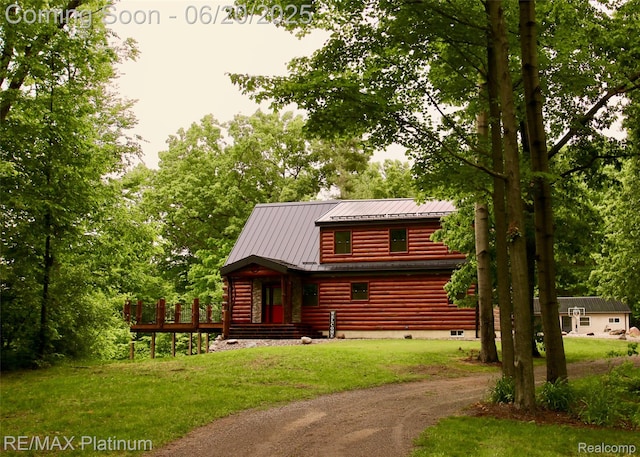 3199 N Loop Ct, Middleville, MI 49333 - log-style house featuring a metal roof, a front lawn, and driveway