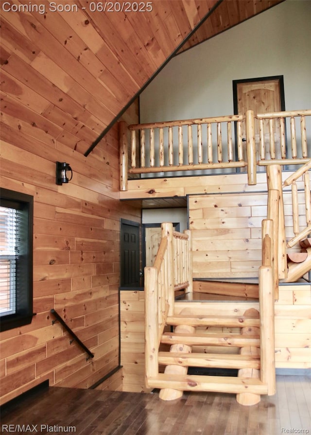 3199 N Loop Ct, Middleville, MI 49333 - stairway featuring lofted ceiling, wooden ceiling, wood walls, and hardwood / wood-style floors