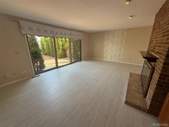 6352 Laurentian Ct, Flint, MI 48532 - unfurnished living room featuring baseboards and light wood-style floors