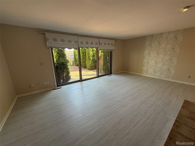 6352 Laurentian Ct, Flint, MI 48532 - spare room featuring baseboards and wood finished floors