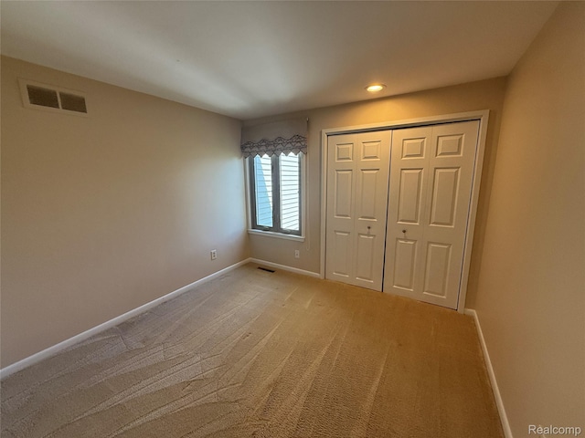 6352 Laurentian Ct, Flint, MI 48532 - unfurnished bedroom with light colored carpet, a closet, and recessed lighting