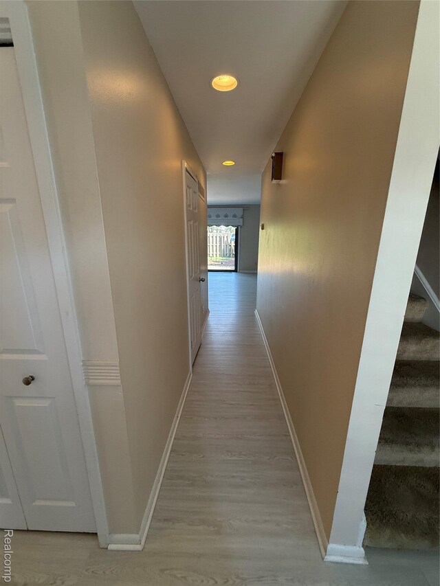 6352 Laurentian Ct, Flint, MI 48532 - hallway featuring light wood-style flooring, stairway, and recessed lighting