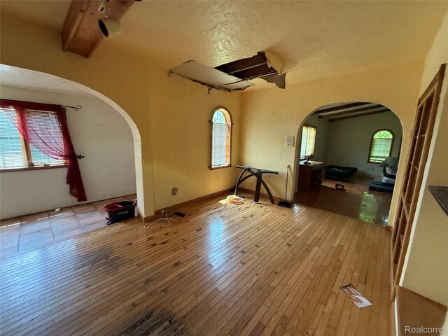 6456 W Court St, Flint, MI 48532 - unfurnished room featuring arched walkways and healthy amount of natural light
