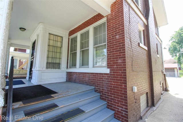 118 Massachusetts St, Highland Park, MI 48203 - view of exterior entry featuring brick siding and covered porch