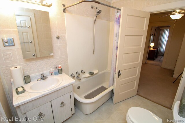 118 Massachusetts St, Highland Park, MI 48203 - full bath with tile walls, vanity, shower / bath combo, ceiling fan, and tile patterned flooring