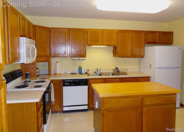 2791 Lochmoor Blvd Unit 21, Lake Orion, MI 48360 - kitchen featuring white appliances, light countertops, brown cabinets, and a center island