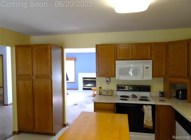 2791 Lochmoor Blvd Unit 21, Lake Orion, MI 48360 - kitchen featuring white appliances, brown cabinets, and a fireplace