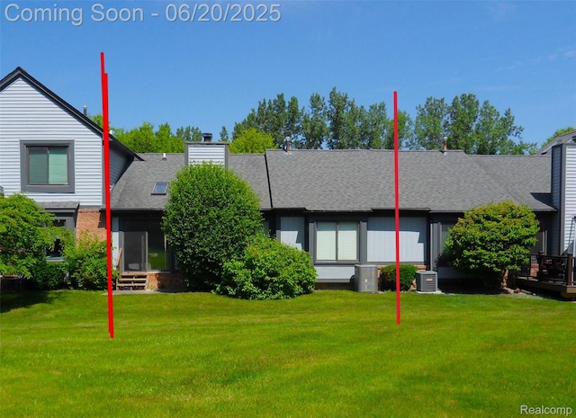 2791 Lochmoor Blvd Unit 21, Lake Orion, MI 48360 - view of front facade featuring a front lawn, a chimney, a shingled roof, and entry steps