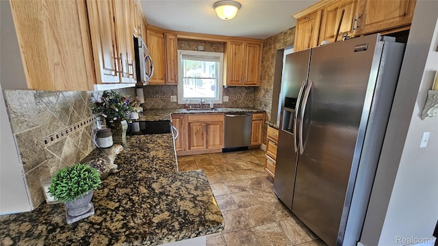 3900 Hillcrest, Highland, MI 48356 - kitchen with appliances with stainless steel finishes, backsplash, and dark stone countertops