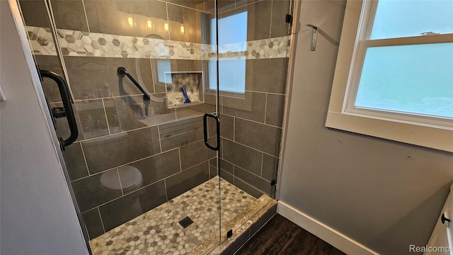 3900 Hillcrest, Highland, MI 48356 - full bathroom featuring a stall shower and wood finished floors