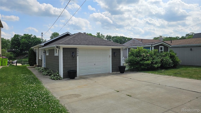 3900 Hillcrest, Highland, MI 48356 - view of home's exterior with driveway, a lawn, a shingled roof, and a detached garage