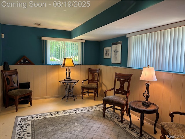 4817 Hickory Dr, Highland, MI 48356 - living area featuring wainscoting and finished concrete floors