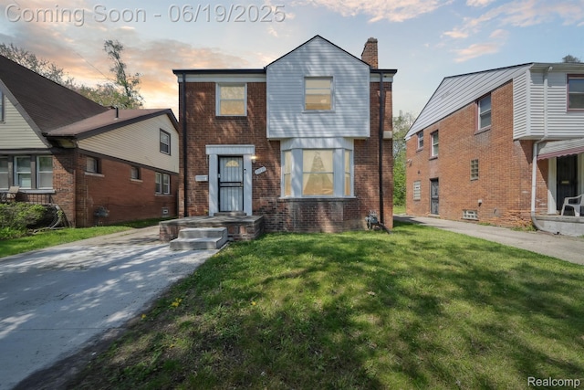 15477 Lauder St, Detroit, MI 48227 - view of front facade with a front yard, brick siding, and a chimney
