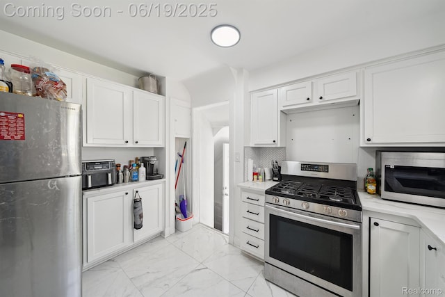15477 Lauder St, Detroit, MI 48227 - kitchen with stainless steel appliances, light marble finish flooring, light countertops, and white cabinetry