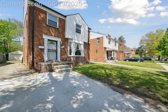 15477 Lauder St, Detroit, MI 48227 - view of property featuring an outdoor structure, a front lawn, brick siding, a detached garage, and a residential view