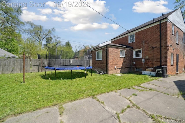 15477 Lauder St, Detroit, MI 48227 - back of property featuring a trampoline and brick siding