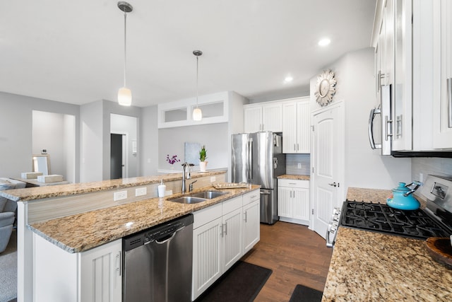 855 Cooks Crossing Dr SE, Byron Center, MI 49315 - kitchen featuring appliances with stainless steel finishes, tasteful backsplash, dark wood finished floors, white cabinets, and recessed lighting