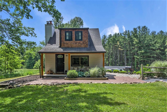8041 Donovan Rd, Dexter, MI 48130 - view of front of property with a front yard, covered porch, a chimney, and a shingled roof