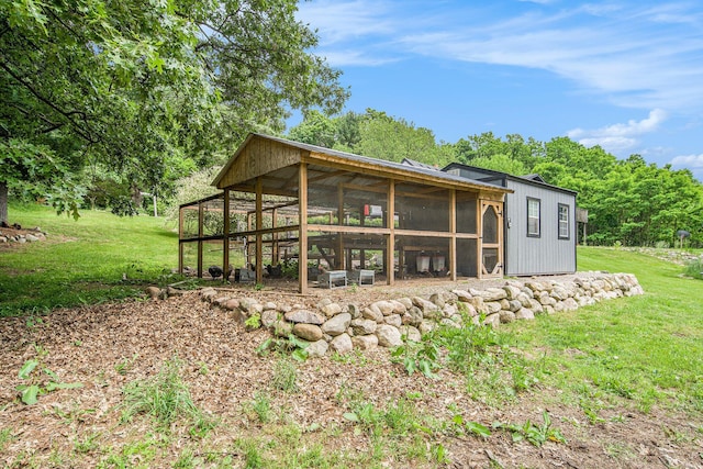 8041 Donovan Rd, Dexter, MI 48130 - rear view of house with exterior structure, a yard, and an outbuilding