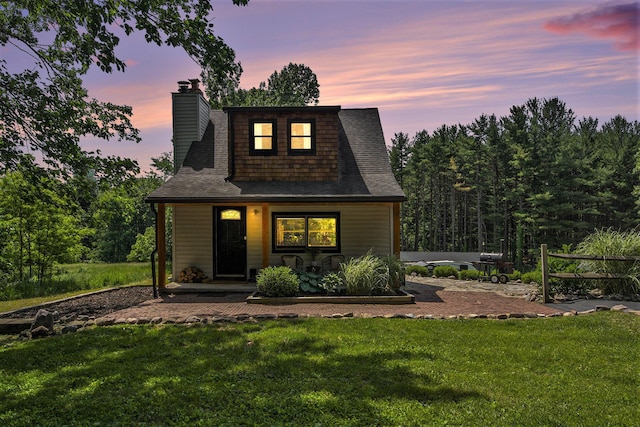 8041 Donovan Rd, Dexter, MI 48130 - view of front of house featuring a chimney, a front lawn, a shingled roof, and covered porch