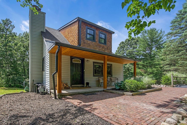 8041 Donovan Rd, Dexter, MI 48130 - view of front of house featuring a porch and a chimney