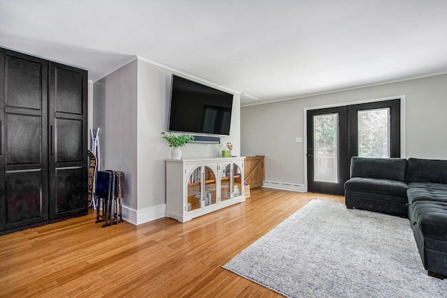 8041 Donovan Rd, Dexter, MI 48130 - living room with light wood-style floors, a baseboard heating unit, crown molding, and french doors