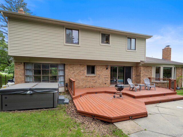1890 Ludgate Ln, Rochester Hills, MI 48309 - rear view of house featuring a hot tub, a chimney, brick siding, and a wooden deck