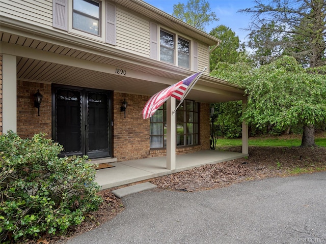 1890 Ludgate Ln, Rochester Hills, MI 48309 - property entrance with covered porch and brick siding