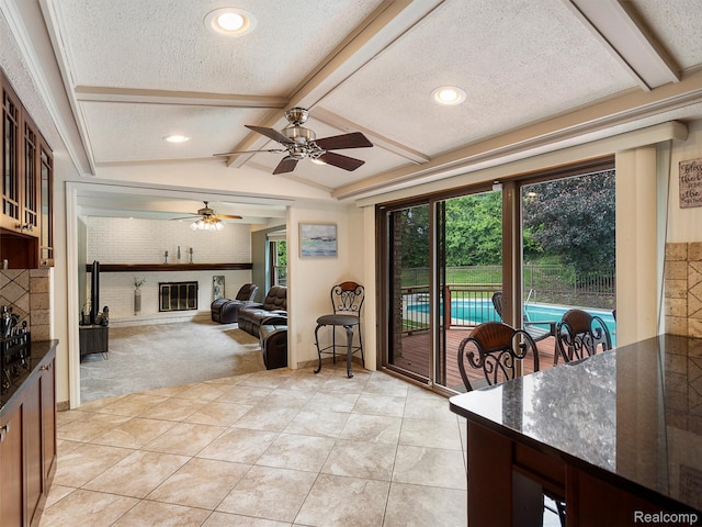 1890 Ludgate Ln, Rochester Hills, MI 48309 - dining area with a brick fireplace, a textured ceiling, light colored carpet, a ceiling fan, and light tile patterned floors