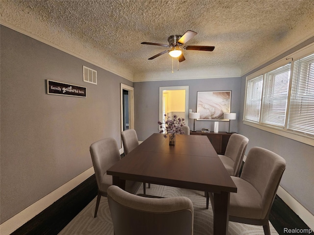 12645 Cloverlawn St, Detroit, MI 48238 - dining area with a textured ceiling, a ceiling fan, and wood finished floors