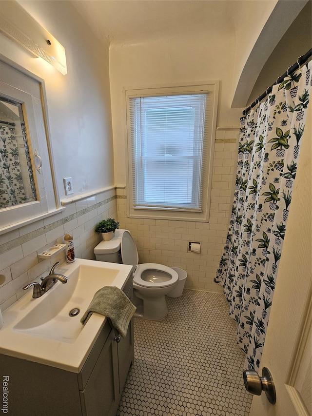 12645 Cloverlawn St, Detroit, MI 48238 - full bathroom with tile walls, vanity, tile patterned flooring, a shower with shower curtain, and wainscoting