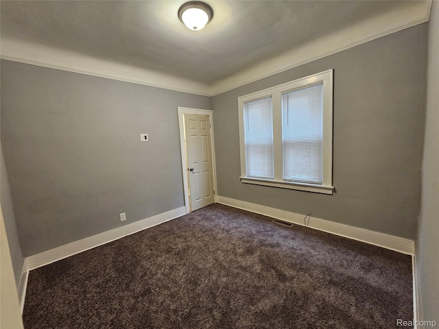 12645 Cloverlawn St, Detroit, MI 48238 - spare room featuring dark colored carpet and baseboards