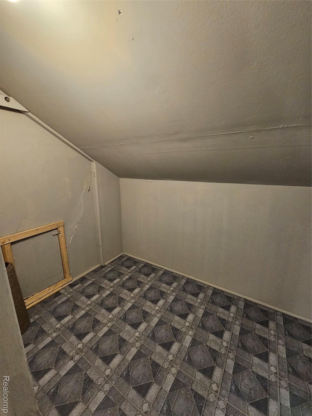 12645 Cloverlawn St, Detroit, MI 48238 - additional living space featuring dark floors and vaulted ceiling