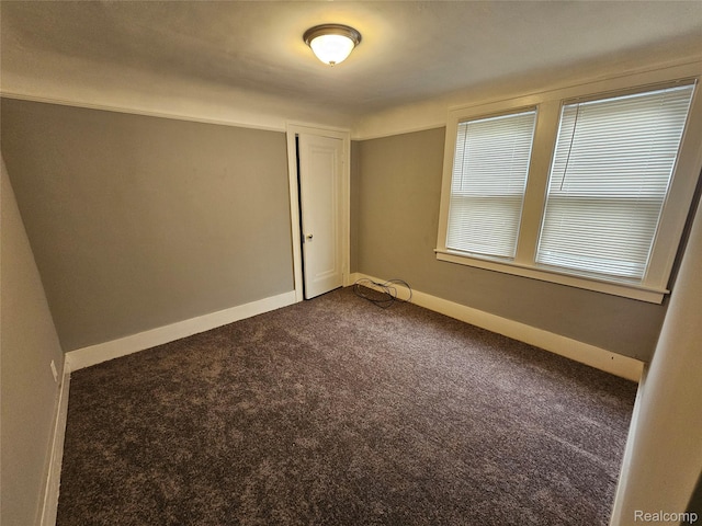12645 Cloverlawn St, Detroit, MI 48238 - spare room featuring dark colored carpet and baseboards