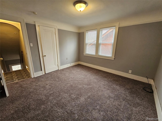 12645 Cloverlawn St, Detroit, MI 48238 - unfurnished bedroom with carpet flooring, arched walkways, and a closet