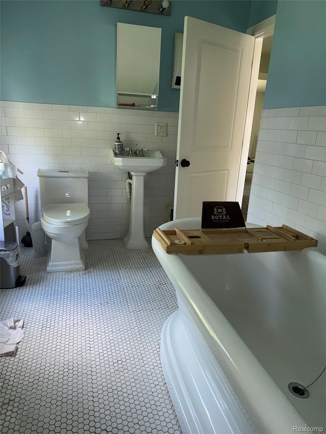 19374 Five Points St, Redford, MI 48240 - bathroom featuring tile walls, wainscoting, and tile patterned flooring