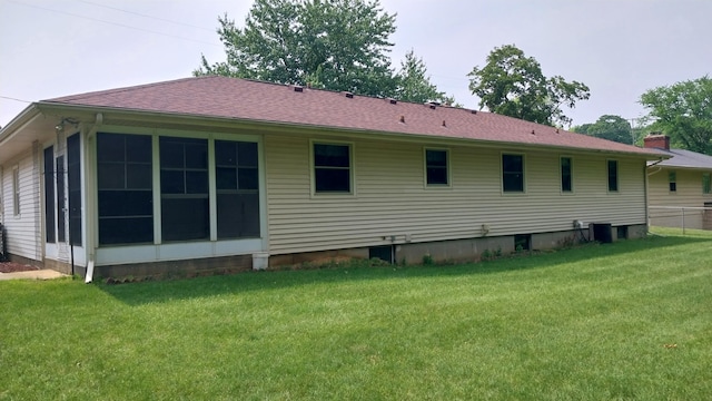 5037 Old Colony Rd, Portage, MI 49024 - rear view of property featuring a yard, a shingled roof, and a sunroom