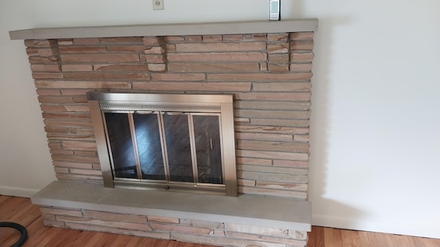 5037 Old Colony Rd, Portage, MI 49024 - detailed view of a glass covered fireplace and wood finished floors
