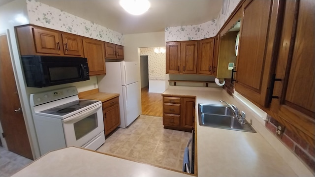 5037 Old Colony Rd, Portage, MI 49024 - kitchen featuring white appliances, wallpapered walls, brown cabinets, light countertops, and light floors