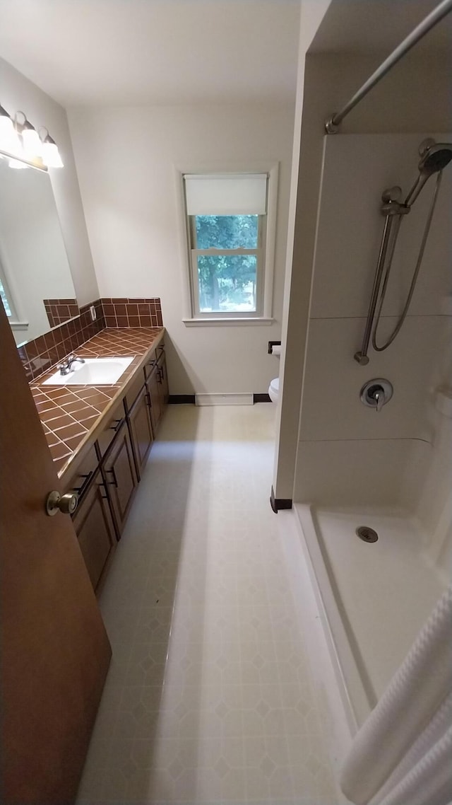 5037 Old Colony Rd, Portage, MI 49024 - full bath featuring a shower, vanity, tile patterned floors, and decorative backsplash