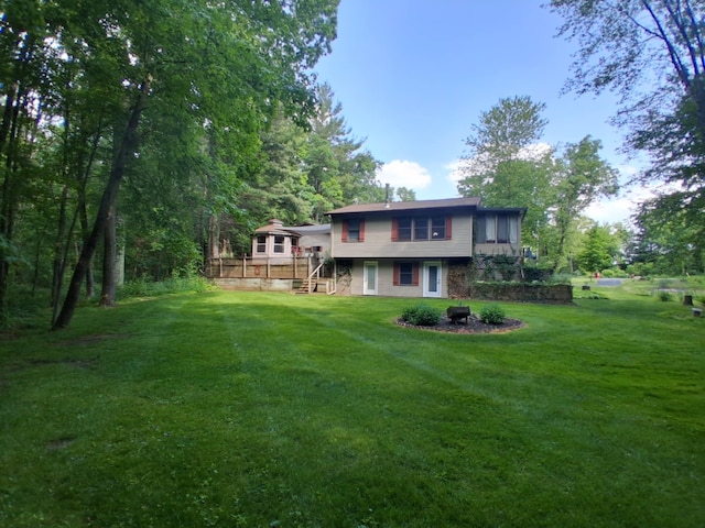 5397 E 80th St, Newaygo, MI 49337 - back of house with a deck, a lawn, and stairs